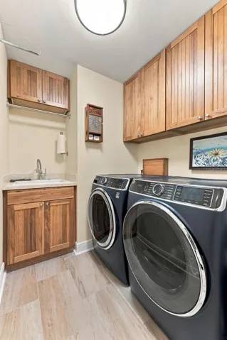 Well-Appointed Laundry Room with Extra Cabinet Storage & New High-End Washer and Dryer