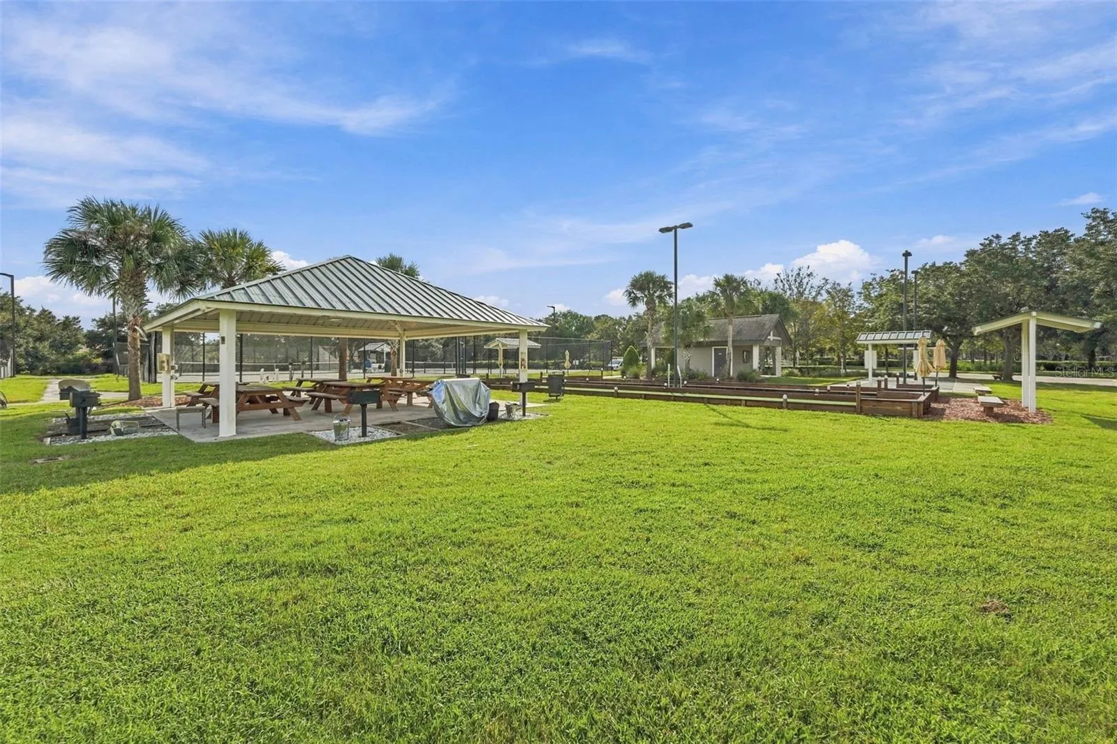 outdoor pavilion with grills and picnic tables