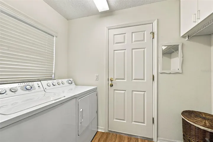 Laund room off kitchen area leading to garage