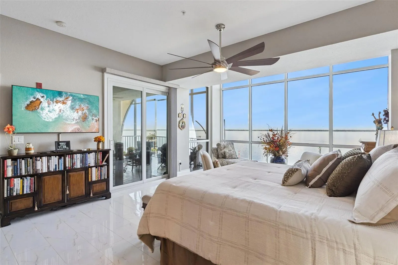 Primary bedroom with balcony access and remote shades.