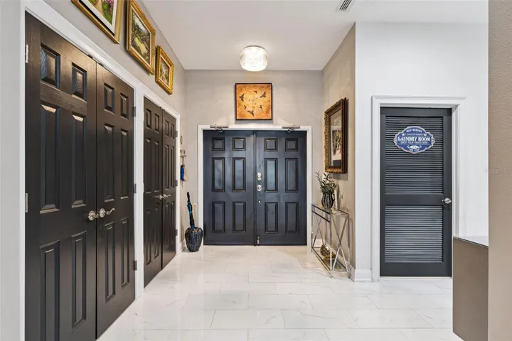 Foyer of residence with double custom closets.