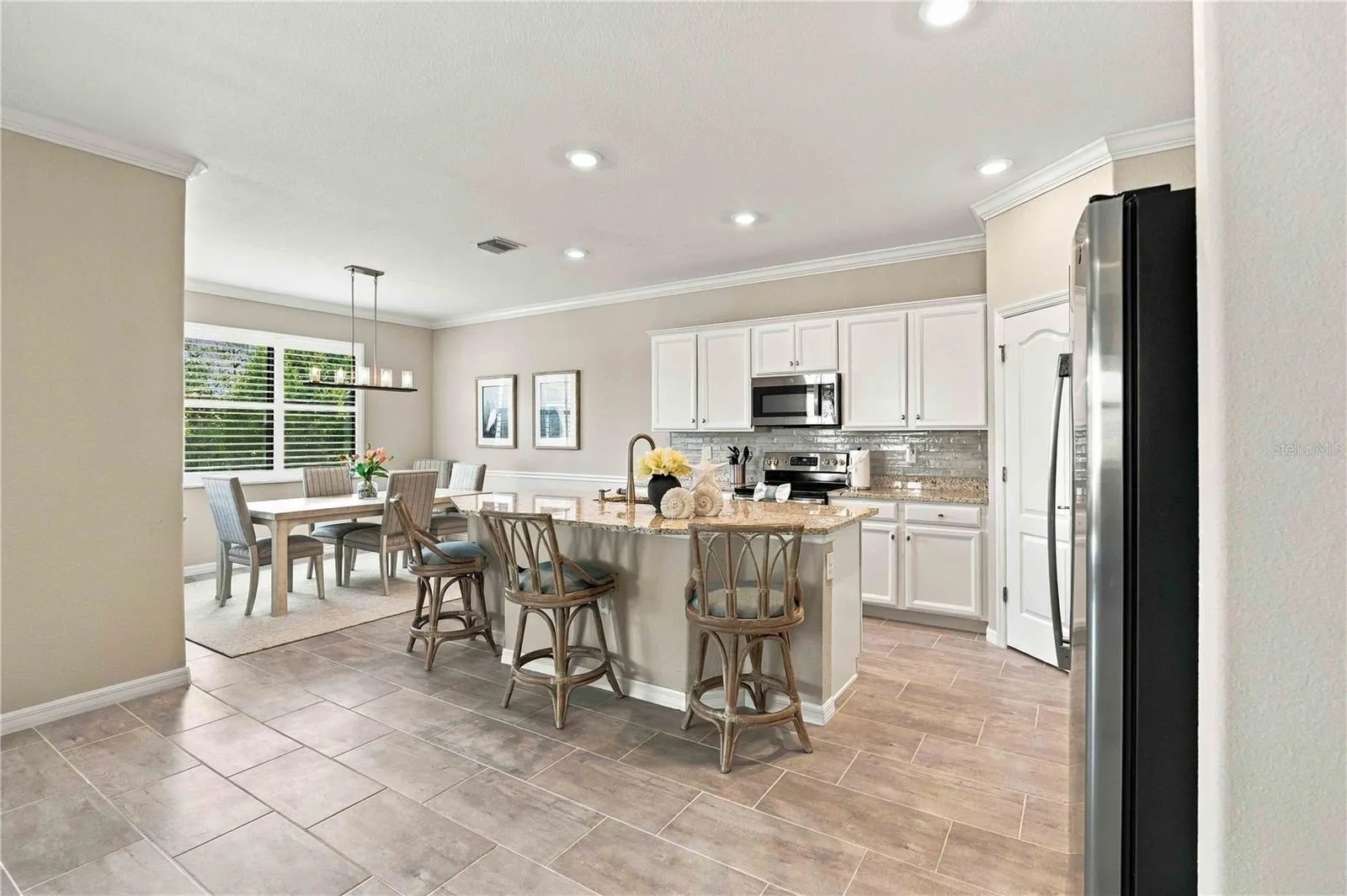 The center island is set for 3 in this home, but easily will seat another 4th chair