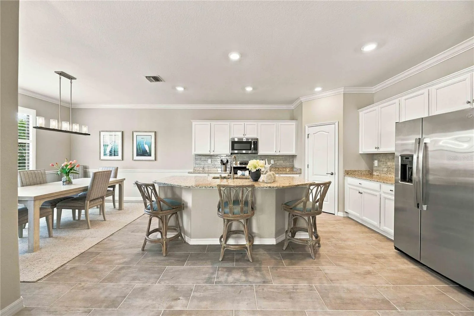 The center island is set for 3 in this home, but easily will seat another 4th chair