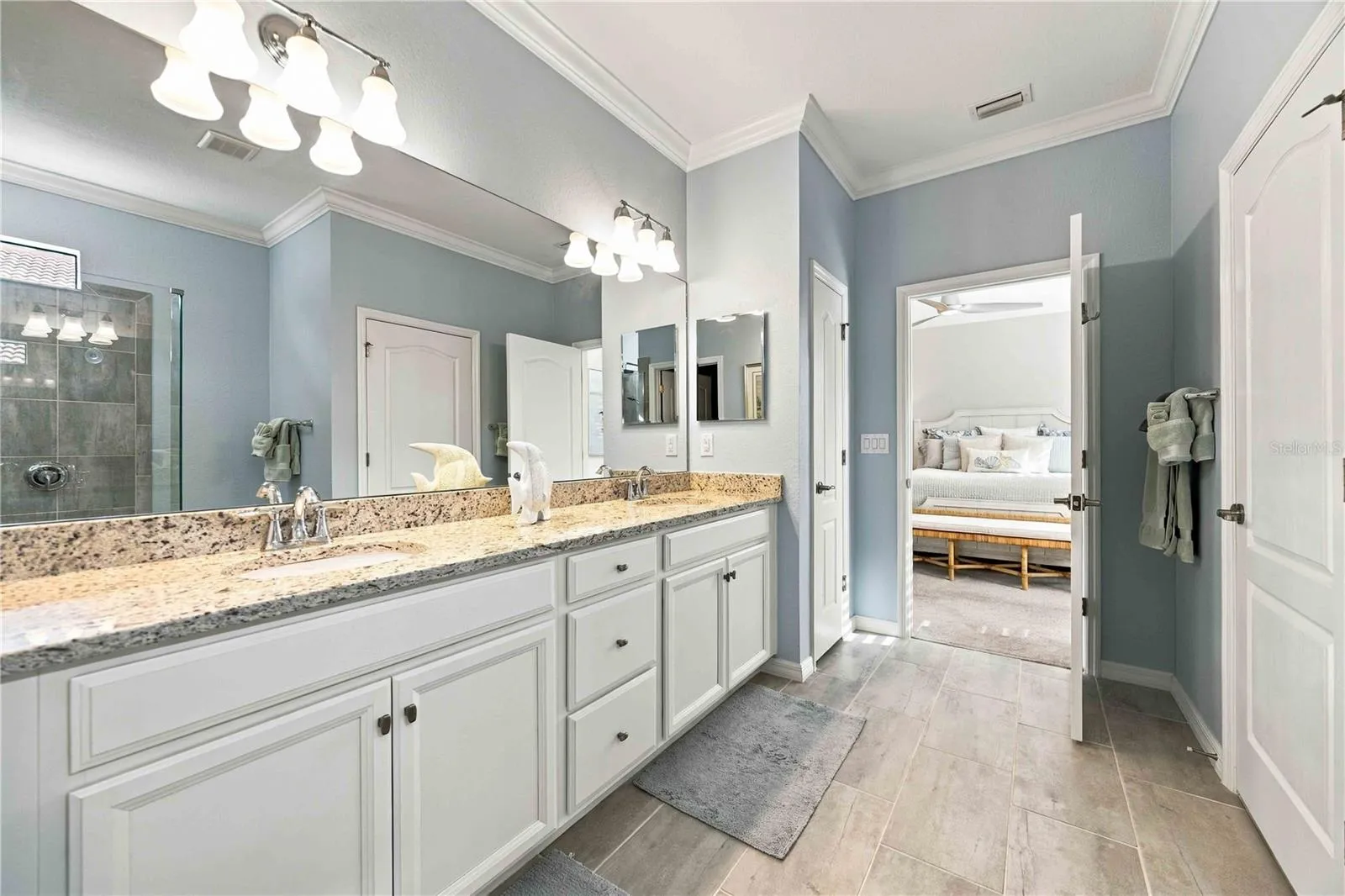 The primary bath has two sinks, walk in shower, private water closet, and walk in closet.