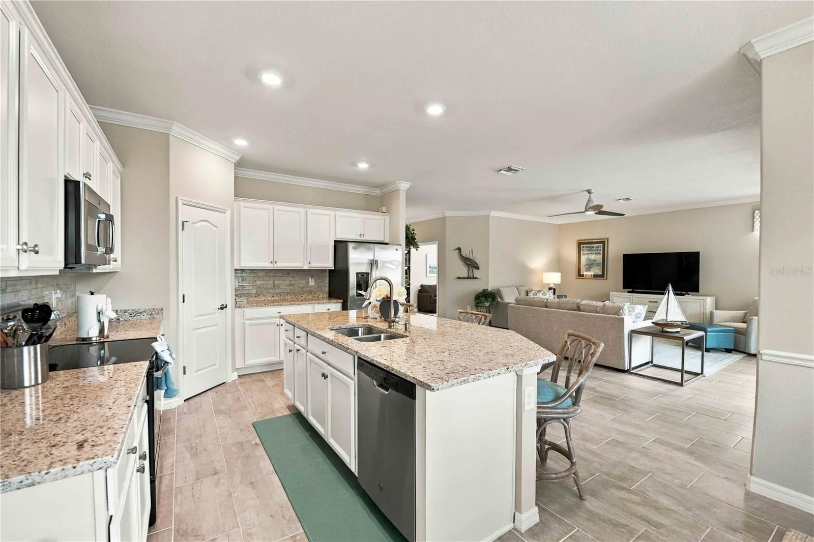 The center island is set for 3 in this home, but easily will seat another 4th chair
