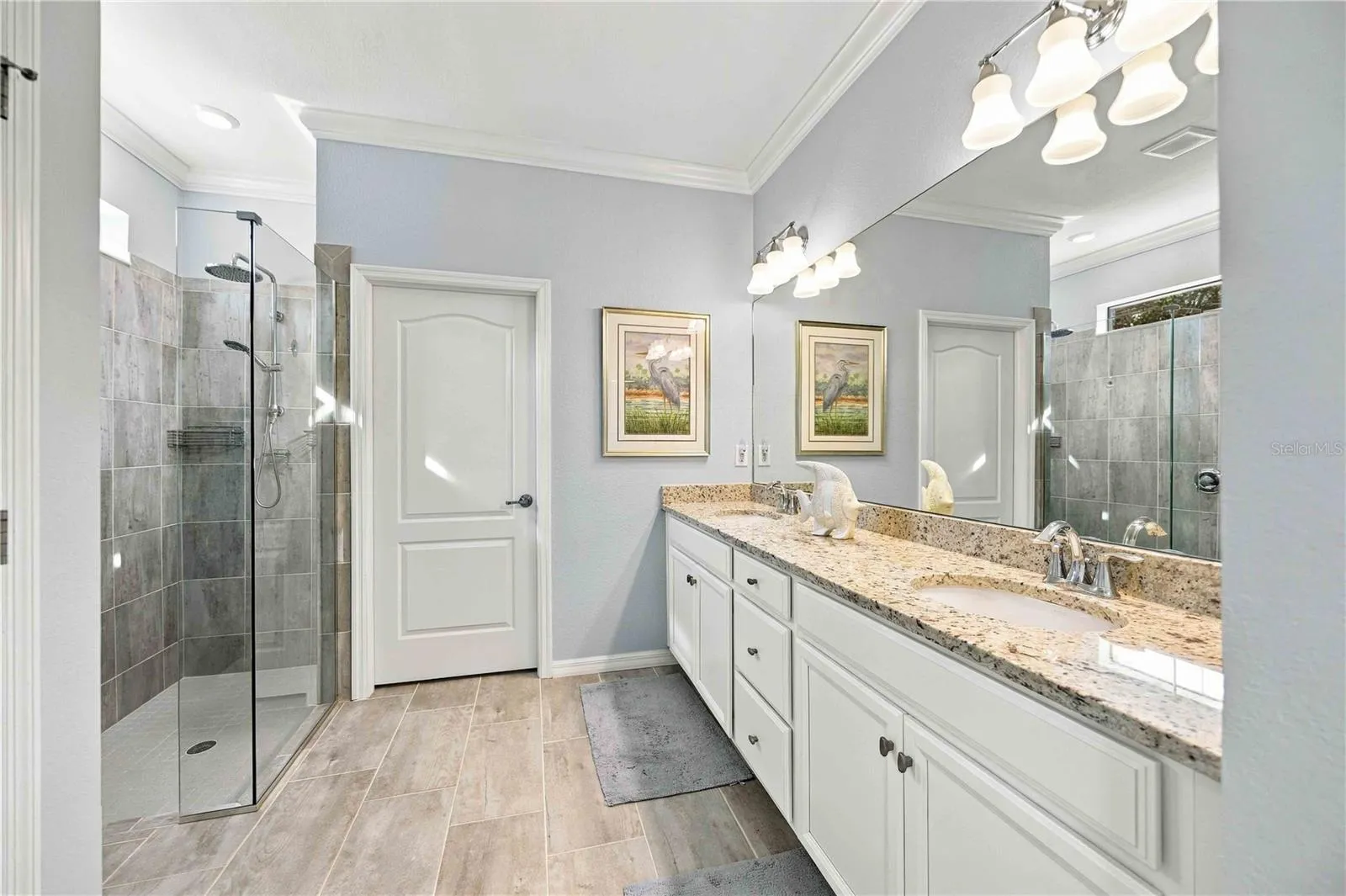 The primary bath has two sinks, walk in shower, private water closet, and walk in closet.