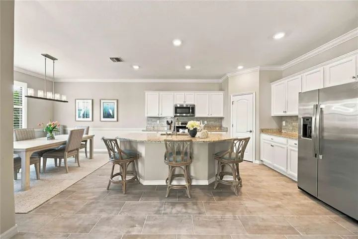 The center island is set for 3 in this home, but easily will seat another 4th chair