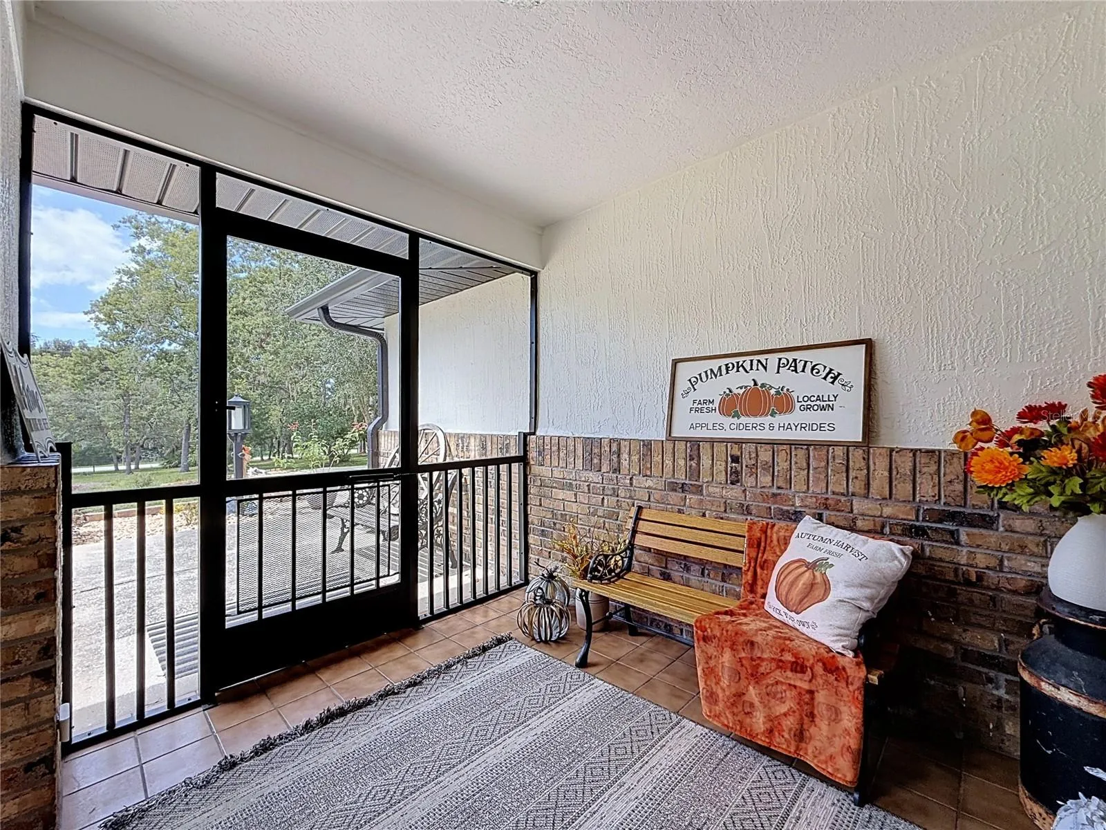 inside the front screened in porch, ceramic tile flooring