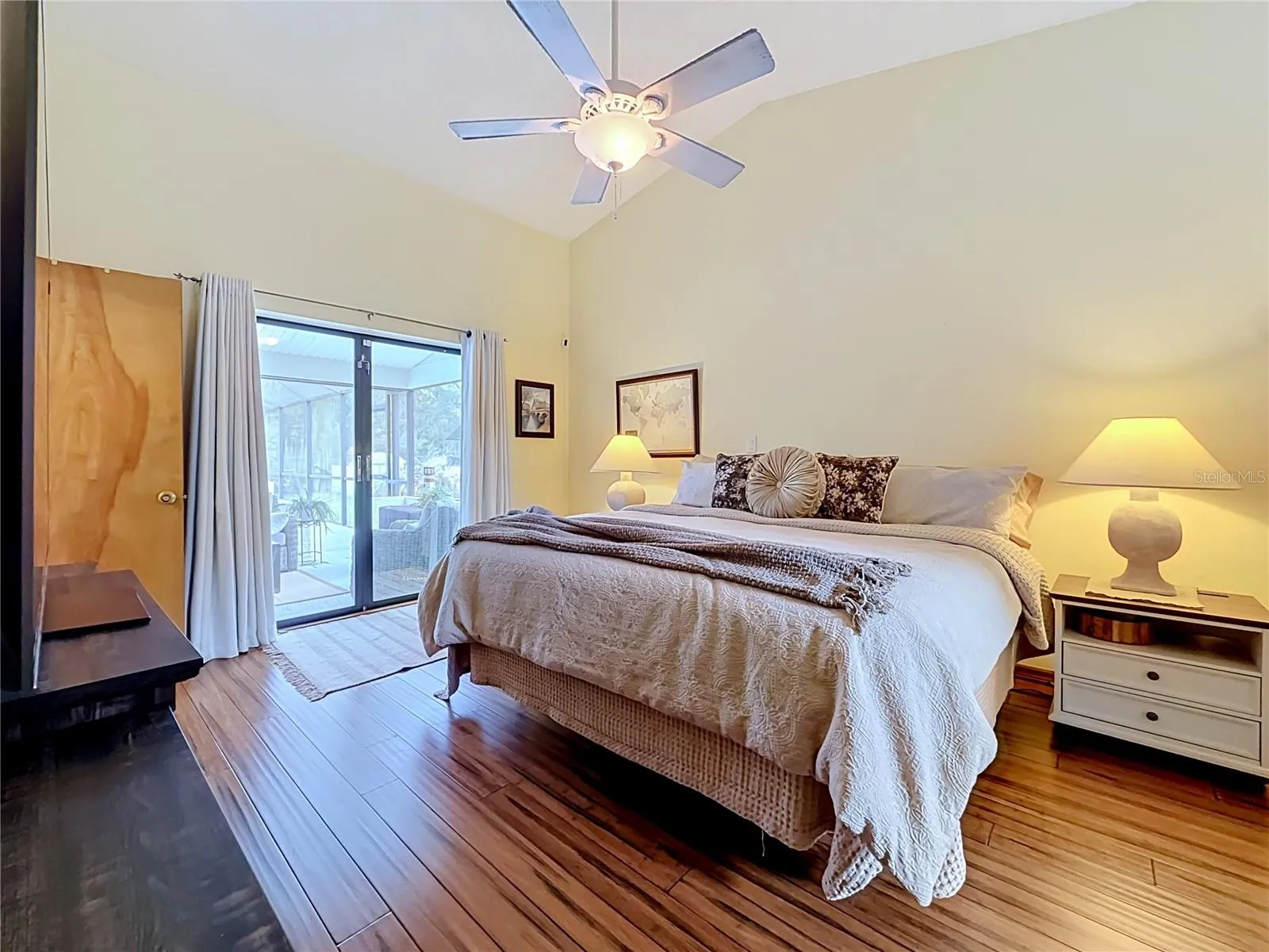 primary bedroom with patio sliders to the pool