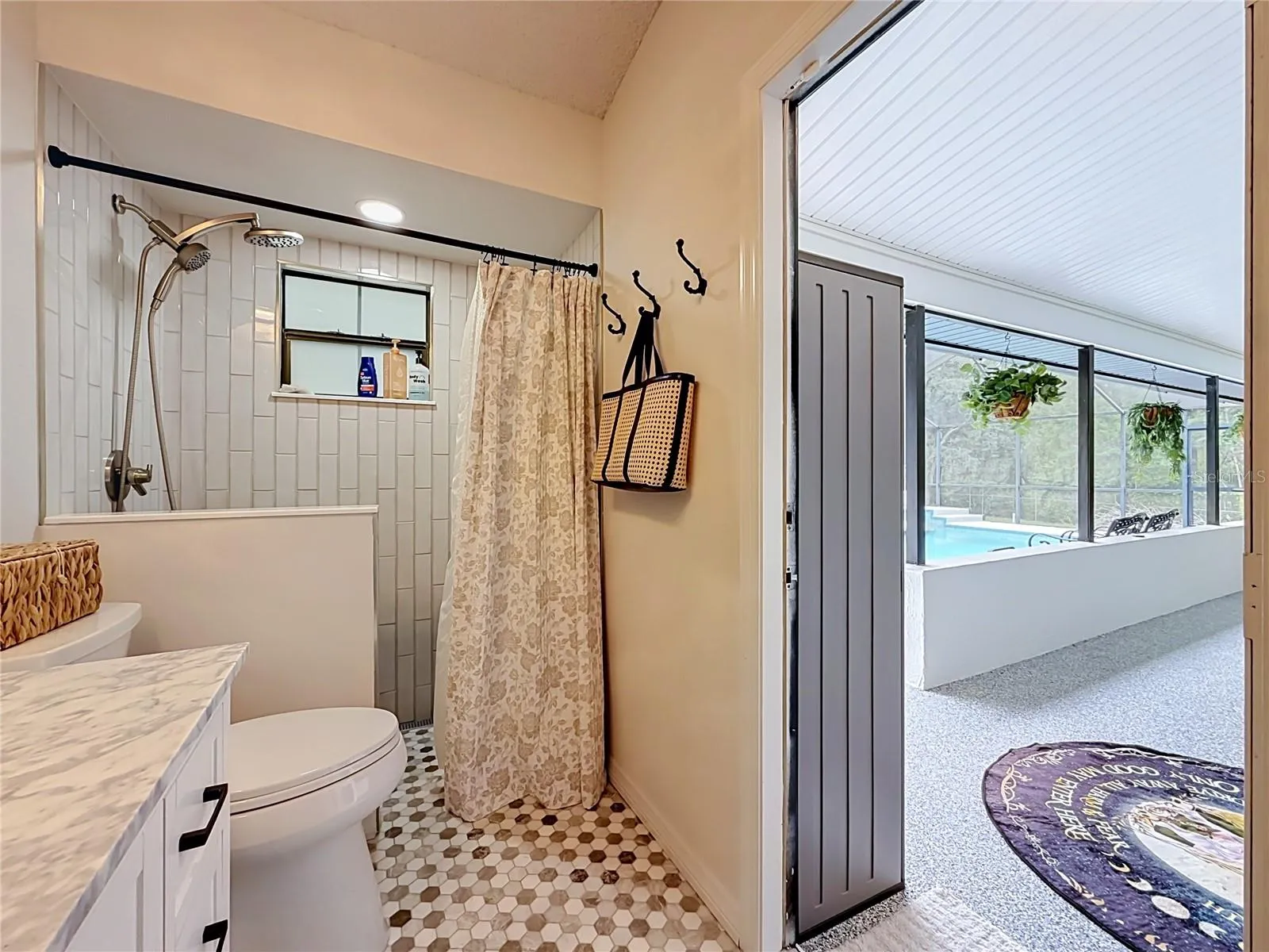 Guest bathroom has a door going out to the pool area.