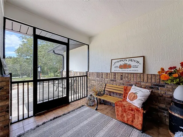 inside the front screened in porch, ceramic tile flooring