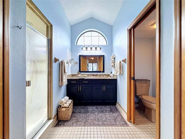 primary bathroom, with walk in shower,  & water closet.