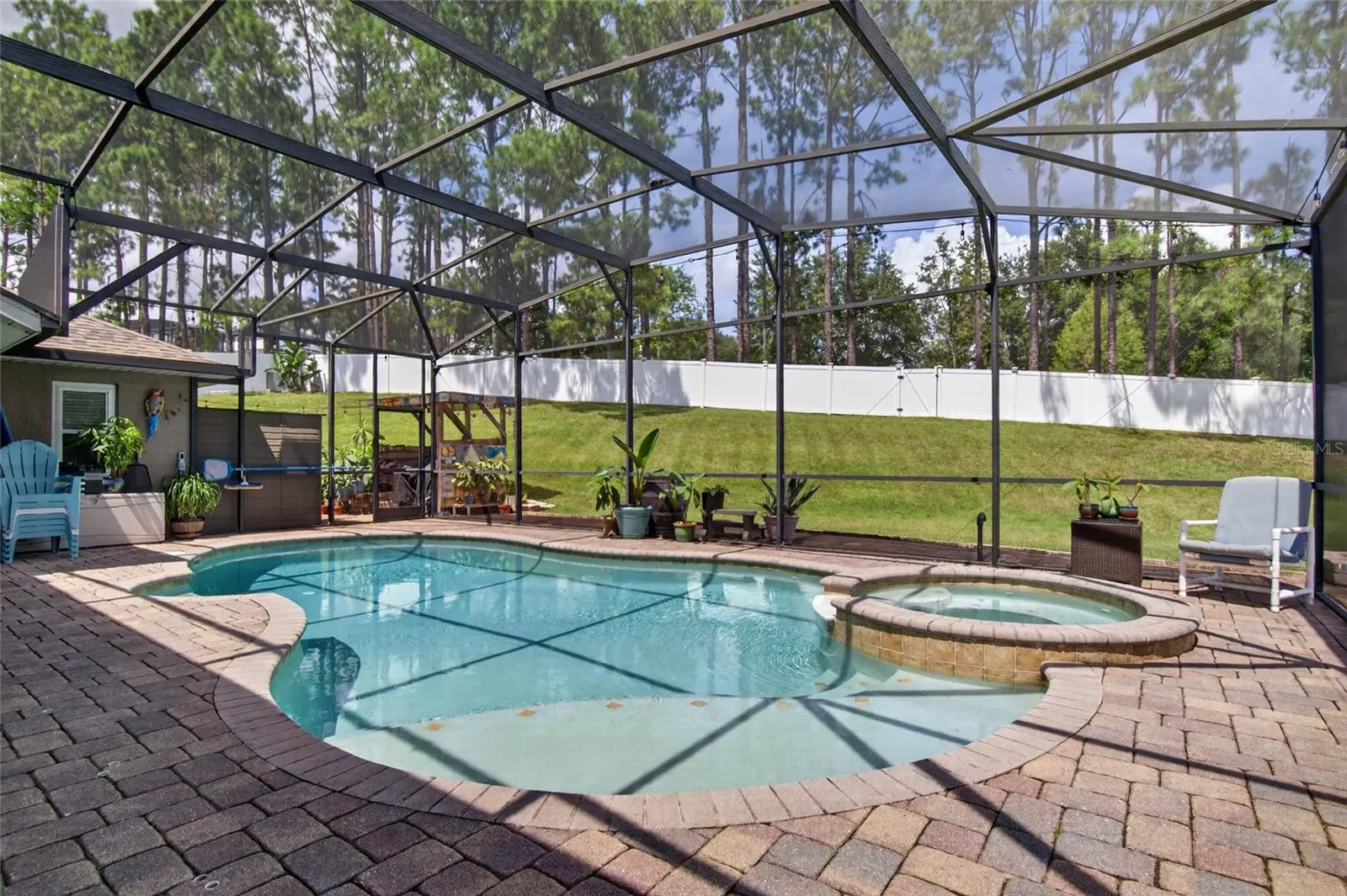 Relax and enjoy your amazing heated and saltwater pool and spa, completely screened with an expansive pavered pool deck.