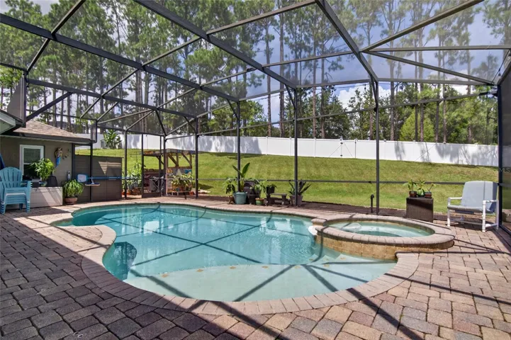 Relax and enjoy your amazing heated and saltwater pool and spa, completely screened with an expansive pavered pool deck.