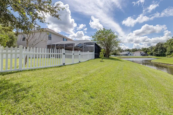 Back of home with private pond and conservation view