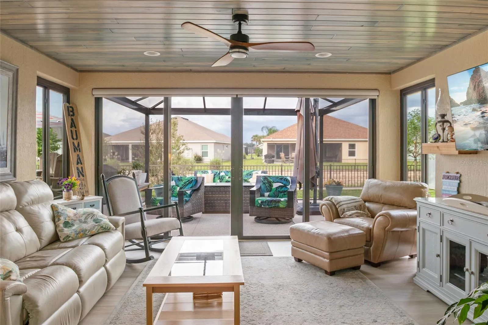 Spacious Florida room with LVP flooring, remote control shades.