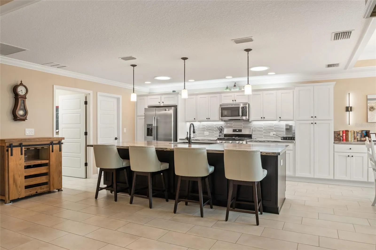 Beautiful backsplash and several pull out drawers in kitchen cabinets and pantry.