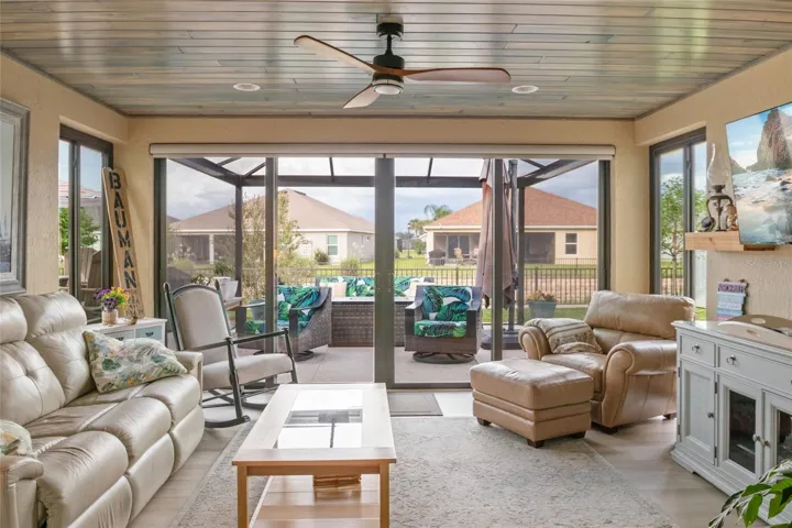 Spacious Florida room with LVP flooring, remote control shades.