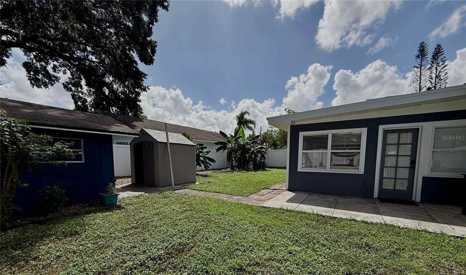 Fenced Backyard with storage sheds