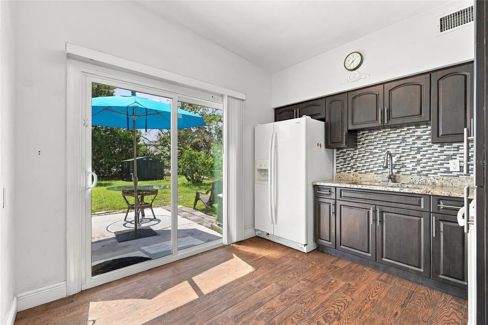 kitchen with new sliding glass door to large backyard