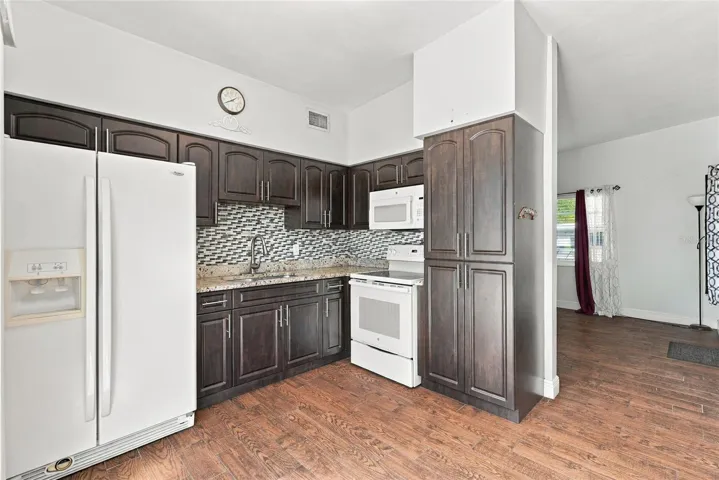 Kitchen with pantry, microwave, range, refrigerator