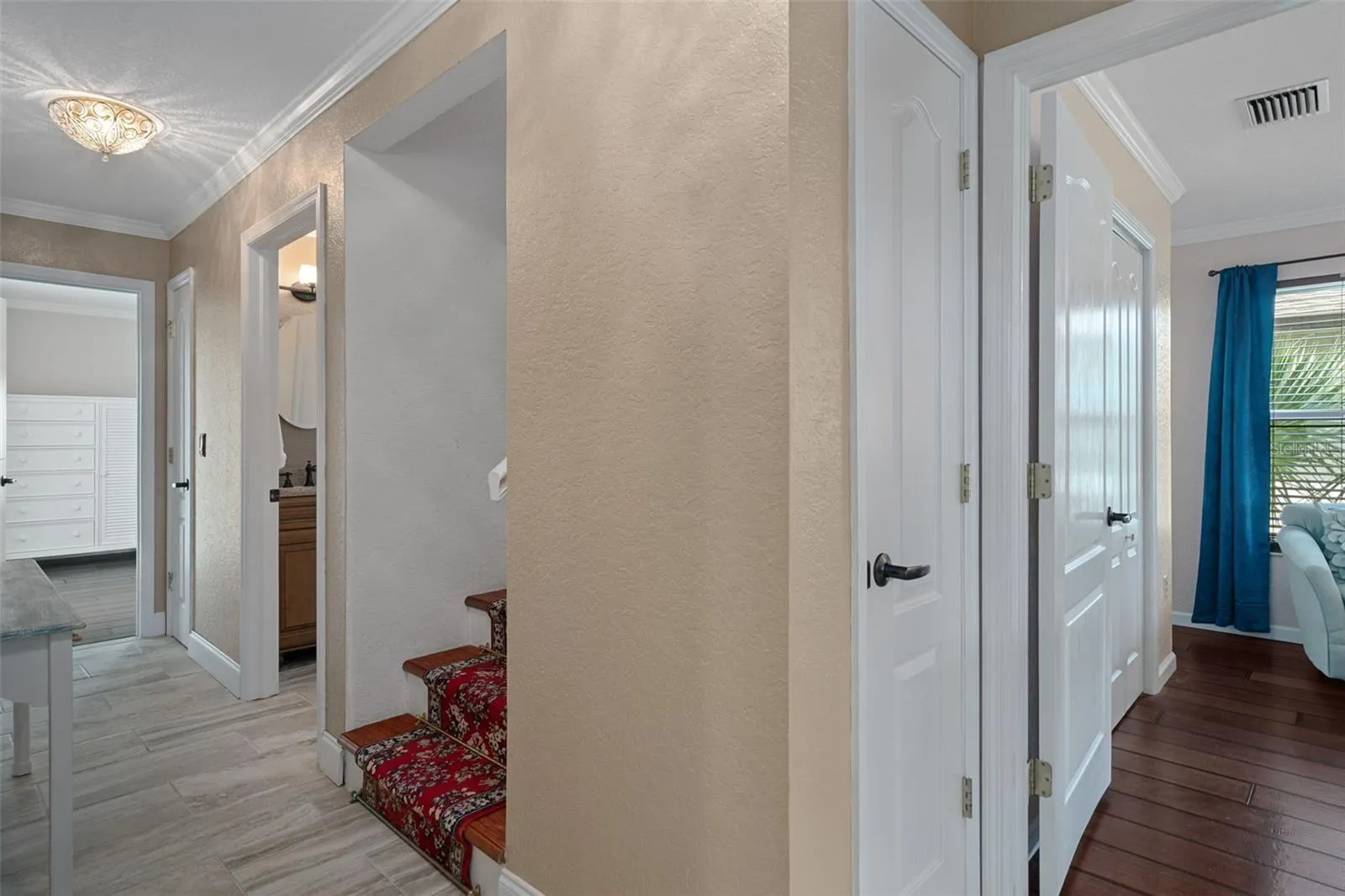 Hall to guest bedrooms and stairs to Primary suite level