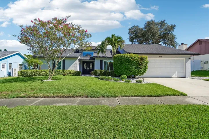 Front Elevation – A full street-facing view showcases the home’s attractive exterior, expansive green lawn, mature landscaping, attached garage, and welcoming front approach.