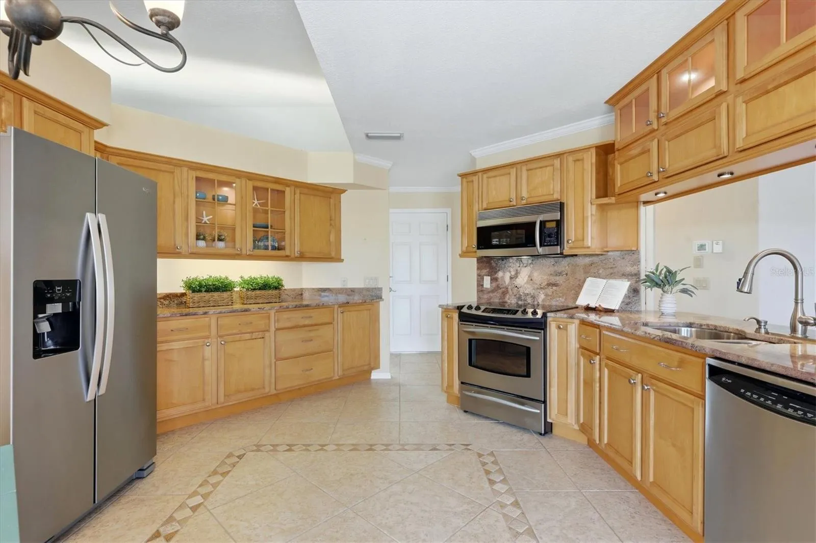 Beautifully updated kitchen with dining nook - garage access at door shown in this photo - family room to the right