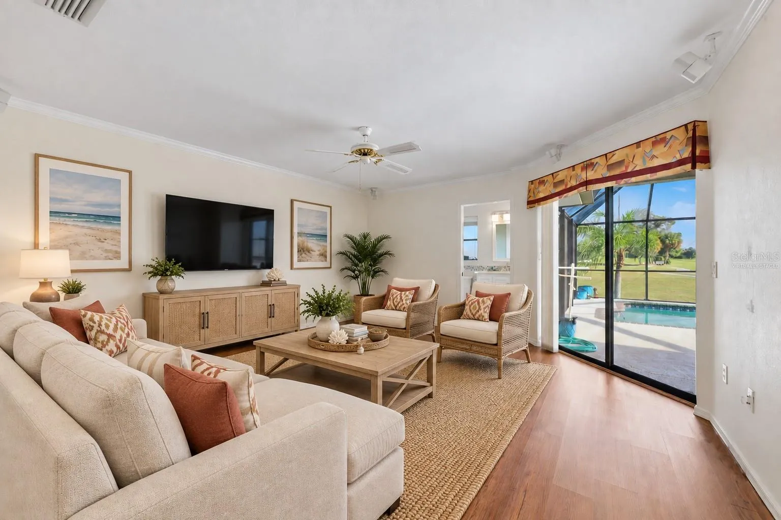Family room virtually staged for your viewing pleasure, open to the kitchen - full bathroom and sliders to the lanai/pool area