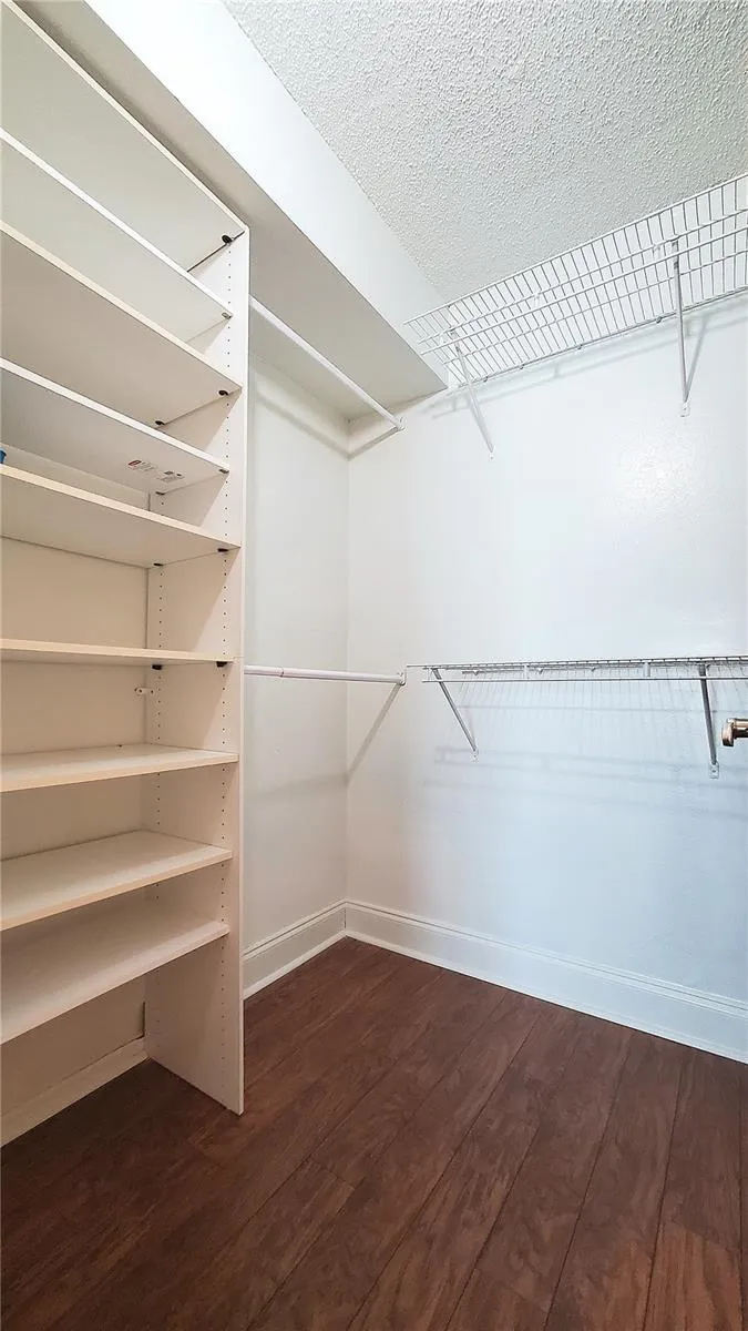 Walk in closet in primary bedroom