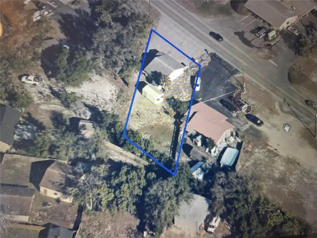 Aerial view with property boundary outlined in blue.
