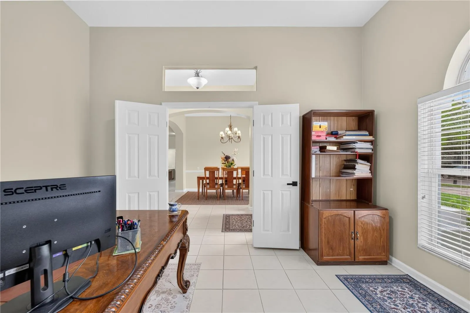 Bedroom #1 features high ceilings, abundant natural light, and double doors.