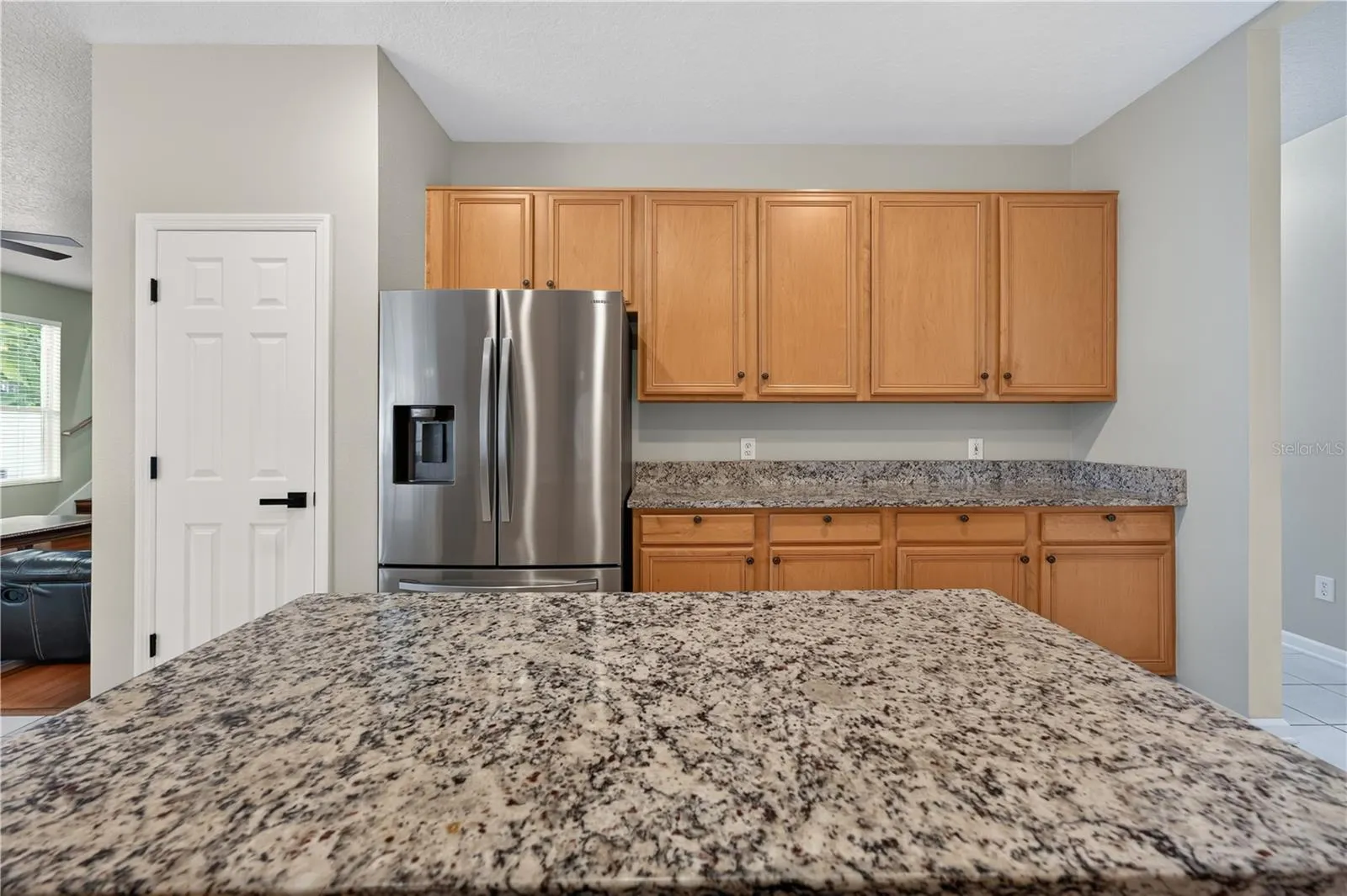 Kitchen featuring abundant cabinetry, granite countertops, stainless steel appliances, and a center island.  Great for entertainment.