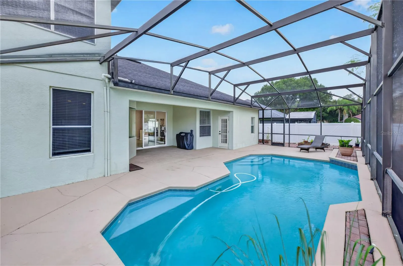 Screened pool and covered patio, perfect for relaxing and entertaining.
