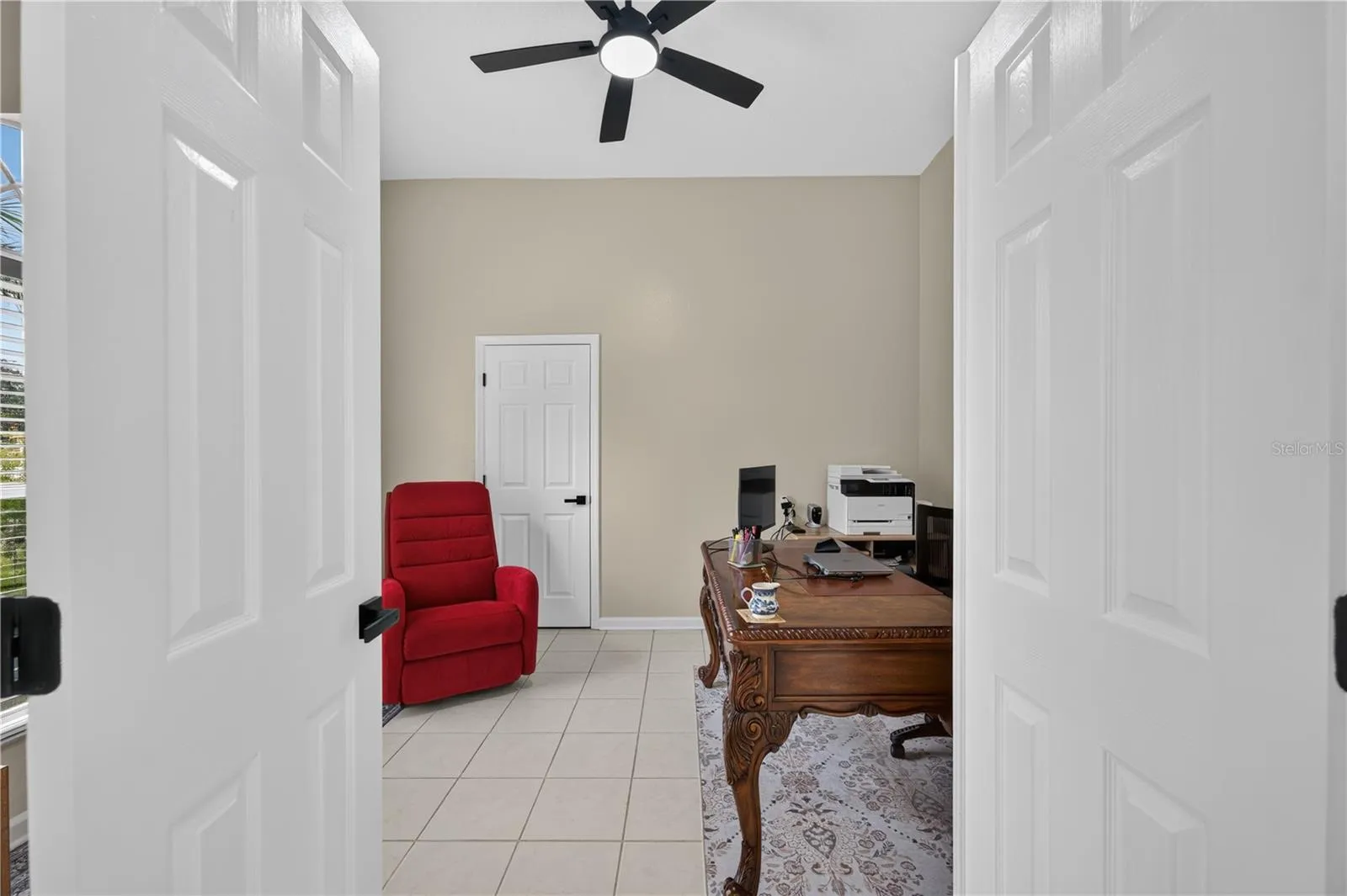 Bedroom #1 with high ceilings, abundant natural light, and flexible use as a home office.