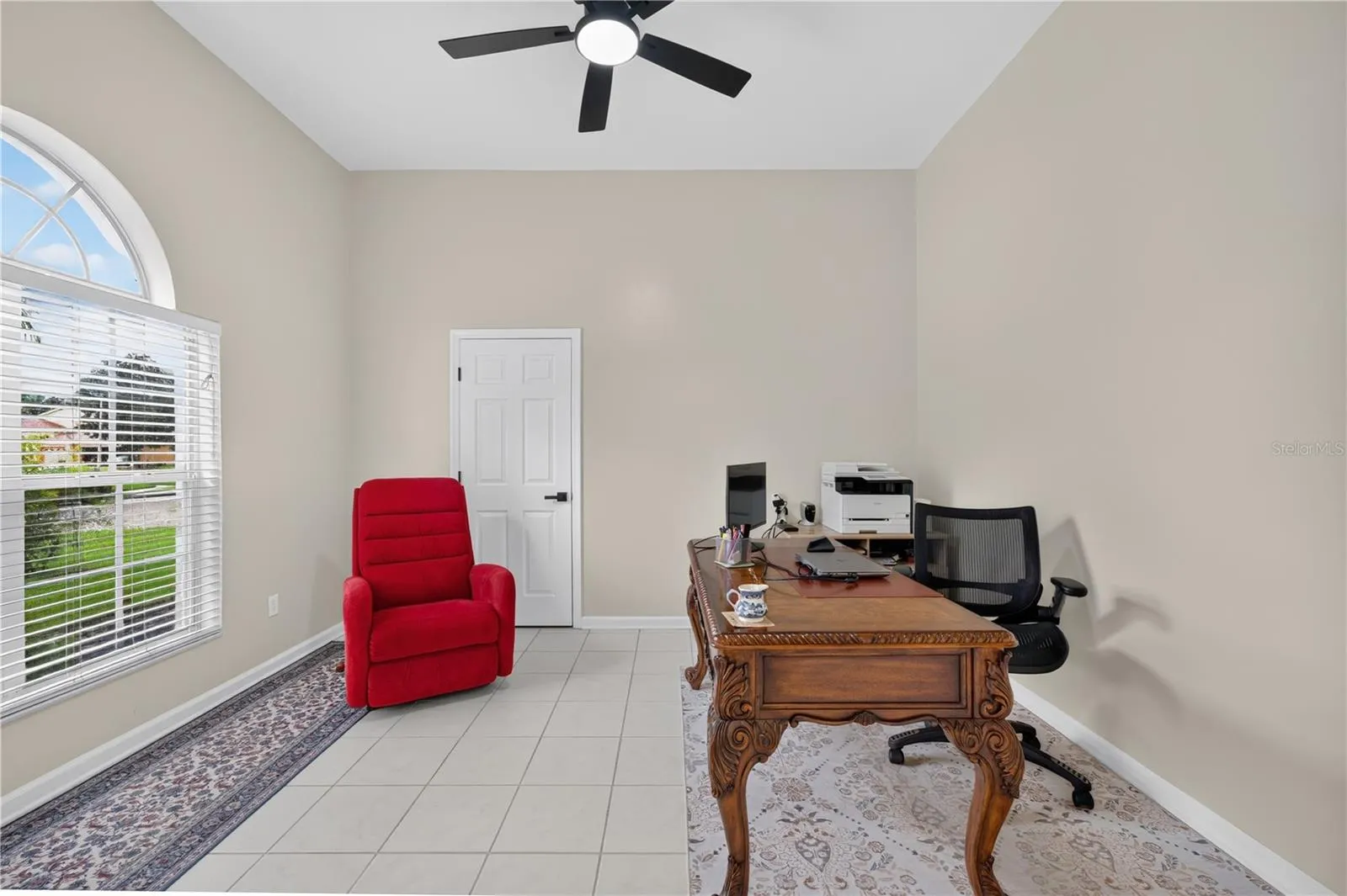 Bedroom #1 with high ceilings, abundant natural light, and flexible use as a home office.