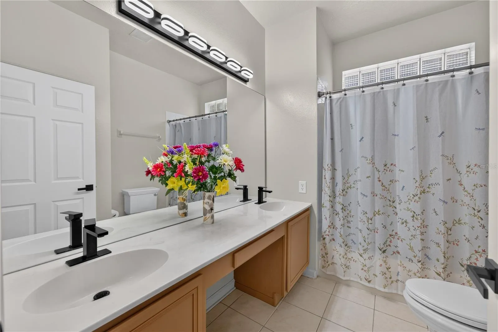 Bathroom #2 features a spacious vanity and a tub and shower combination.