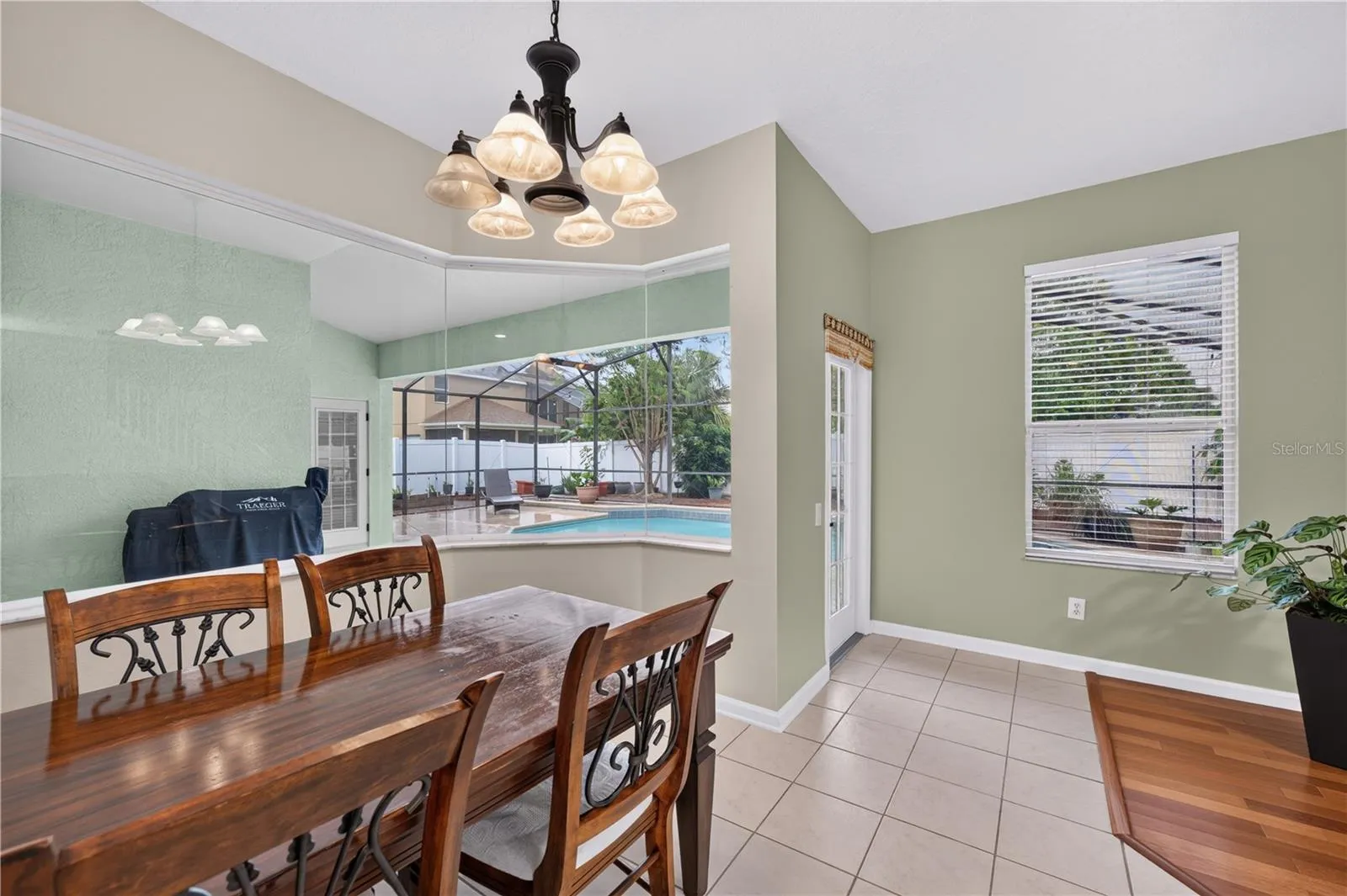 Bright dinette overlooking the screened pool.