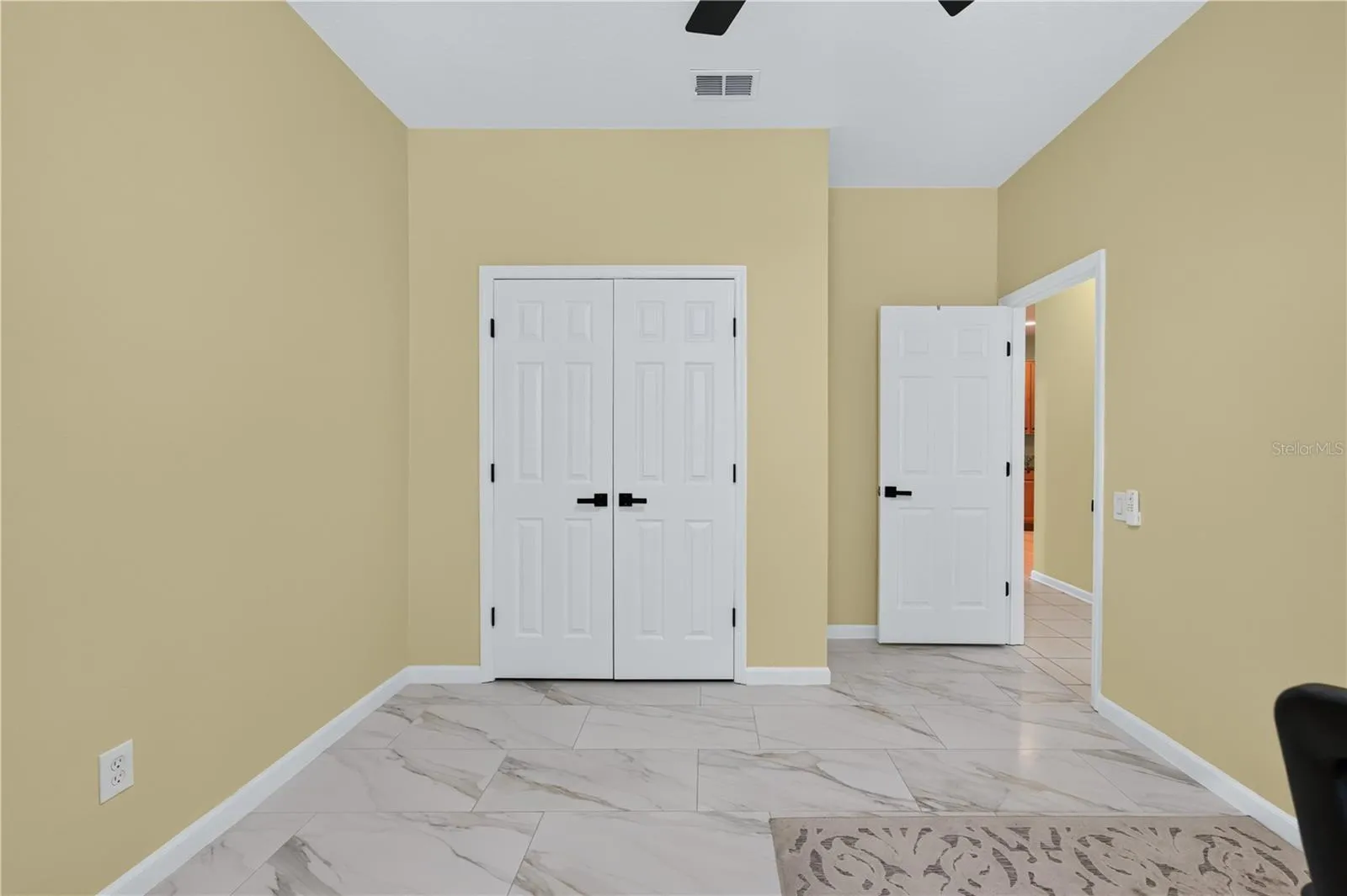 Bedroom #4 with high ceilings, a ceiling fan, and flexible use as a home office.