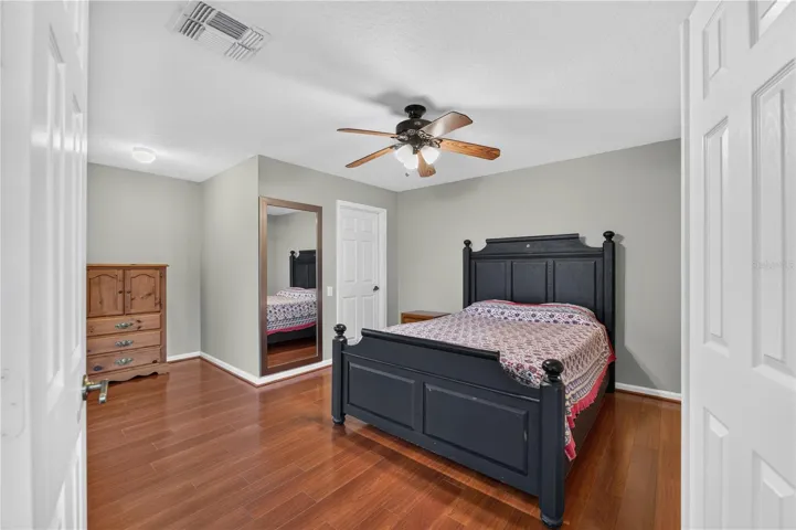 Bedroom #5 is featuring wood floorings, a ceiling fan, ample closet space, and a private En-Suite bathroom.