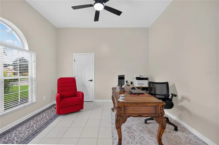 Bedroom #1 with high ceilings, abundant natural light, and flexible use as a home office.