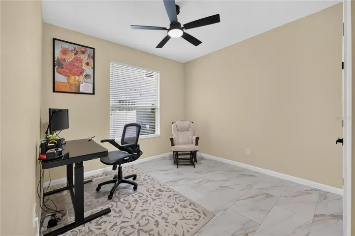 Bedroom #4 with high ceilings, a ceiling fan, and flexible use as a home office.