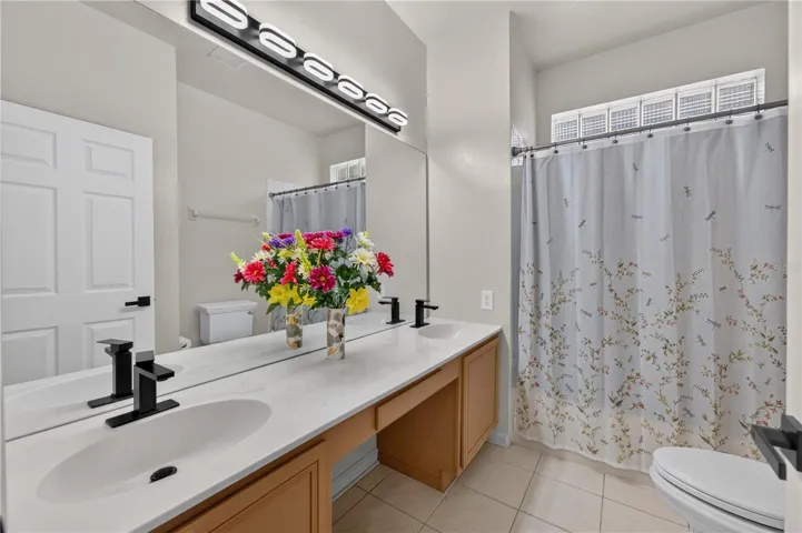 Bathroom #2 features a spacious vanity and a tub and shower combination.