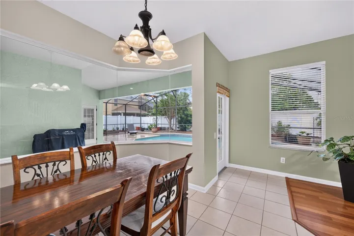 Bright dinette overlooking the screened pool.