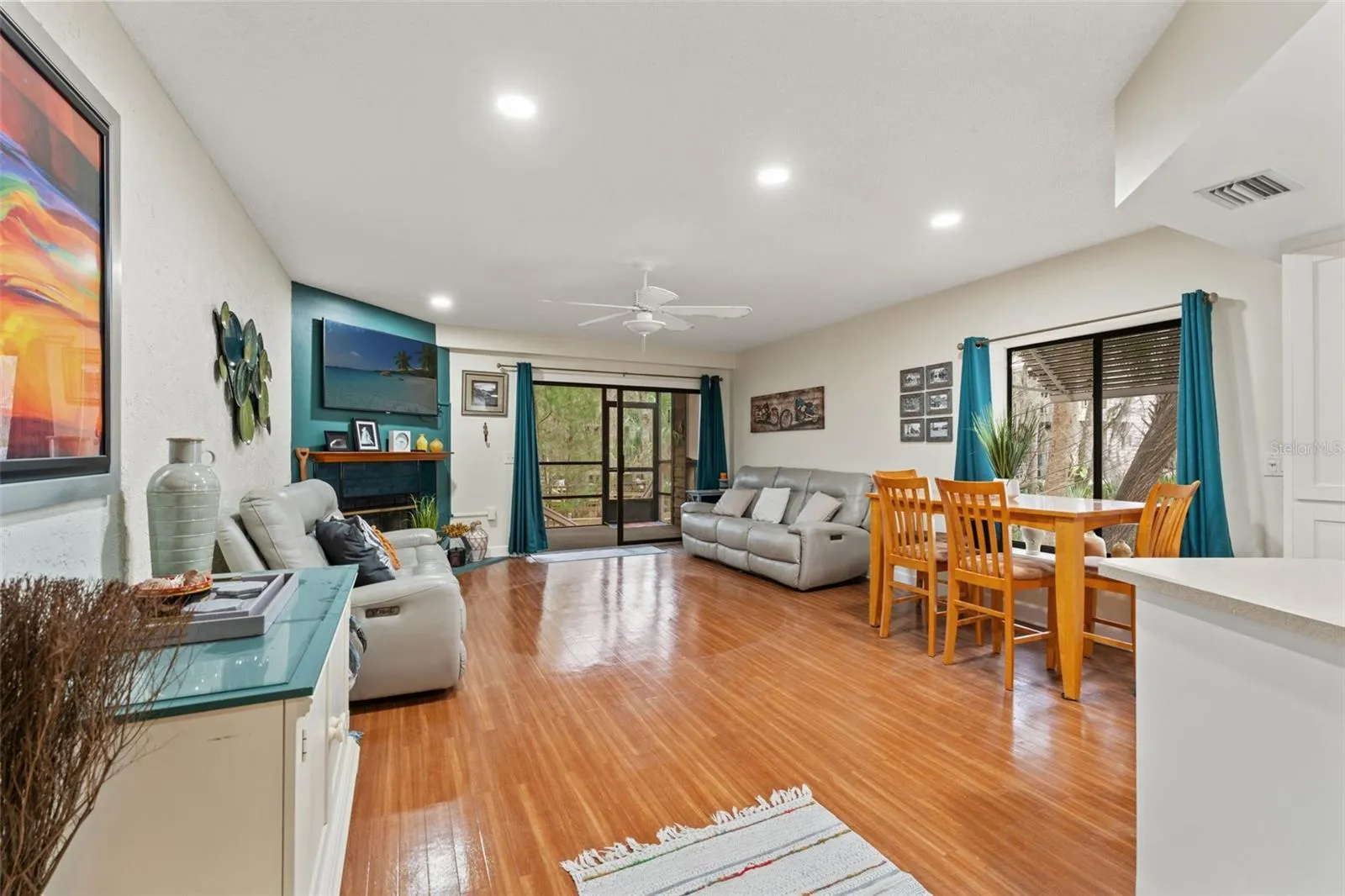 Living Room + Dining Room.  There is a wood-burning fireplace in the living room and a screened-in porch.