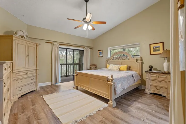 Primary Bedroom, which also features a screened-in porch and a walk-in closet.