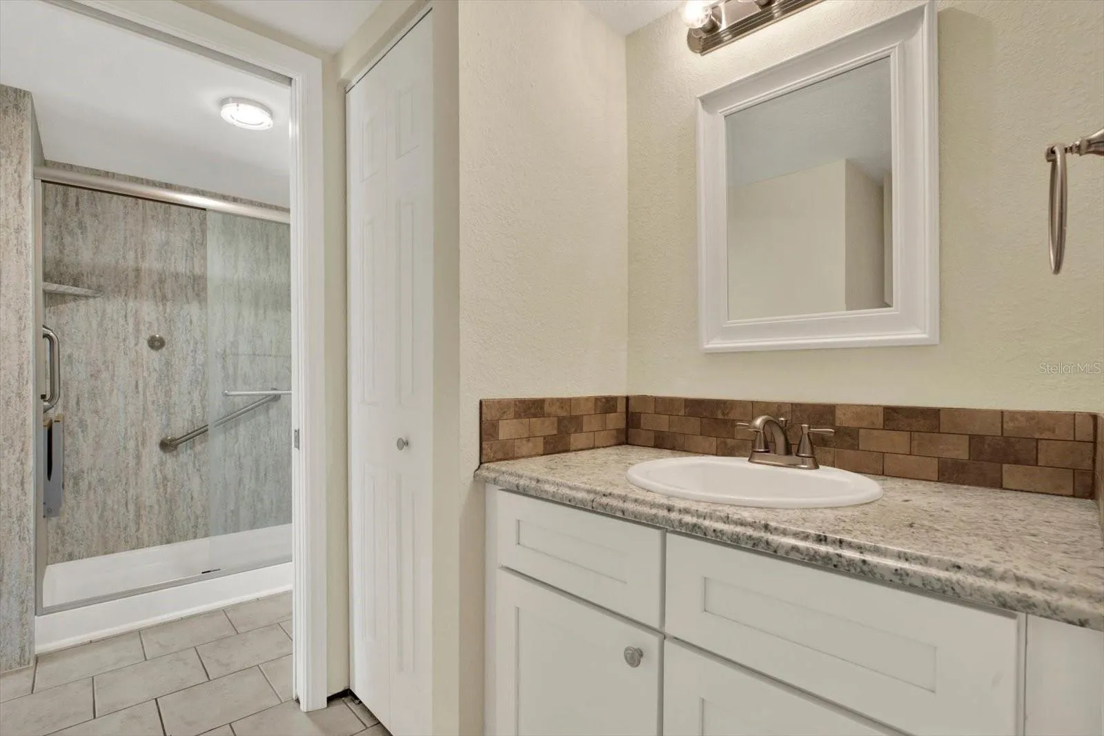 JACK N JILL STYLE BATHS 2 LAVATORIES AND 1 WALK-IN SHOWER WITH SAFETY HAND BARS AND SEAT