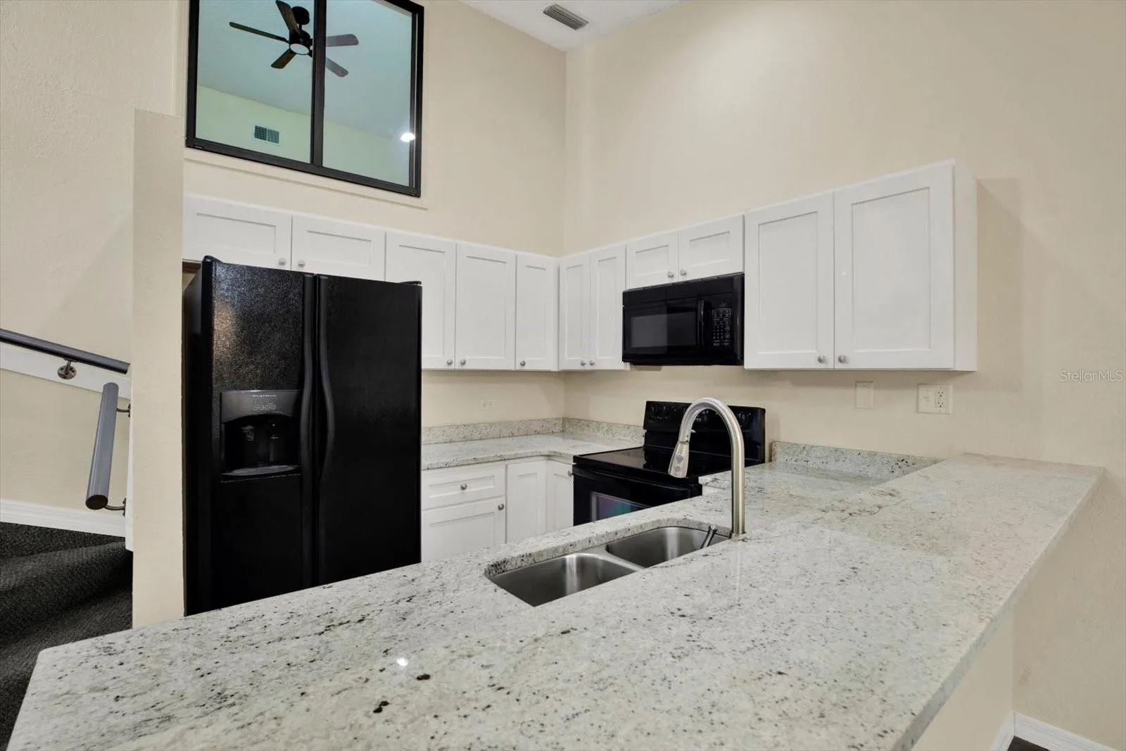 KITCHEN WITH BEAUTIFUL GRANITE COUNTERTOPS UPDATED CABINETRY WITH SOFT CLOSE DOORS