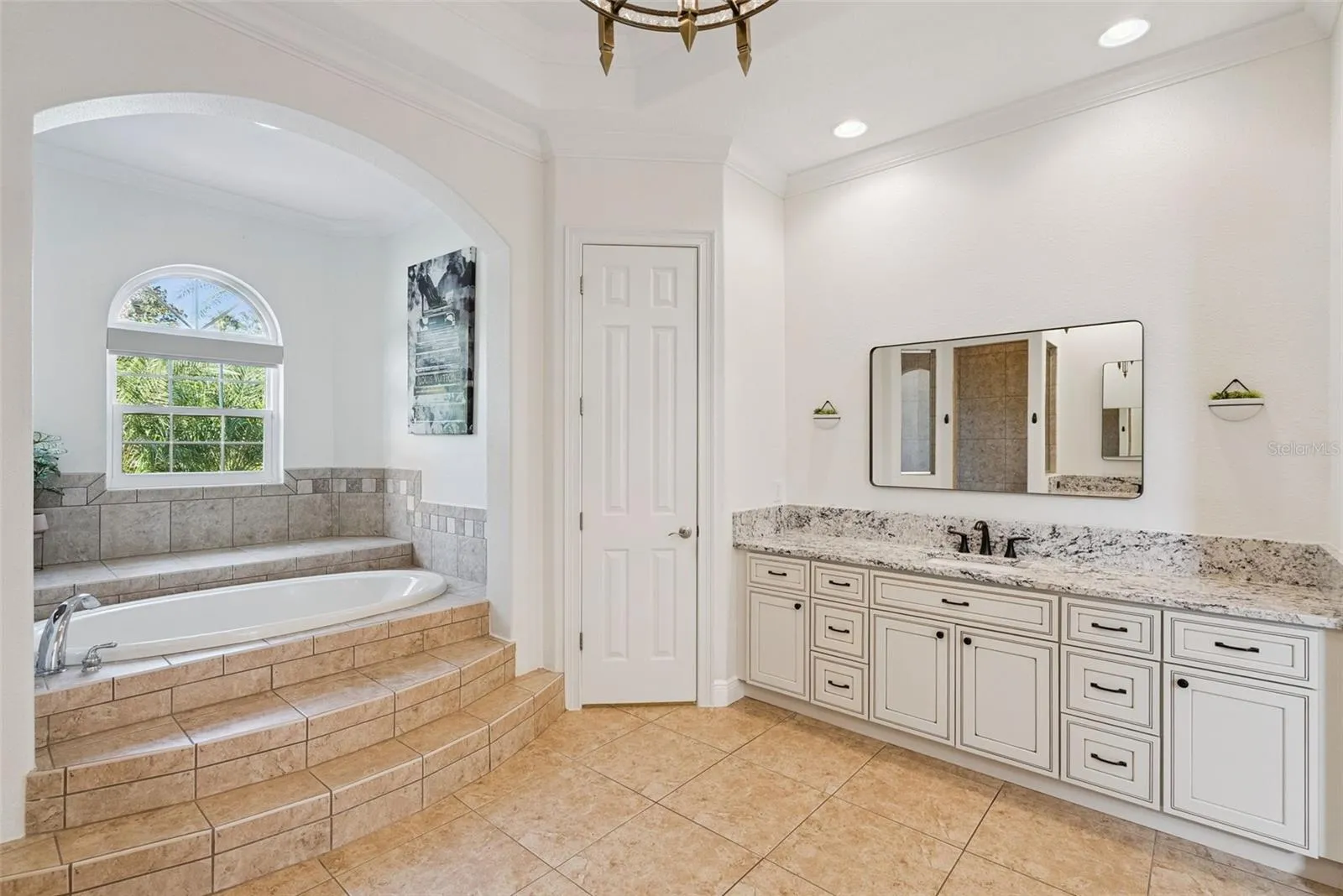Primary BathroomSpacious primary bathroom with updated countertops, sinks and cabinetry in both vanity areas.