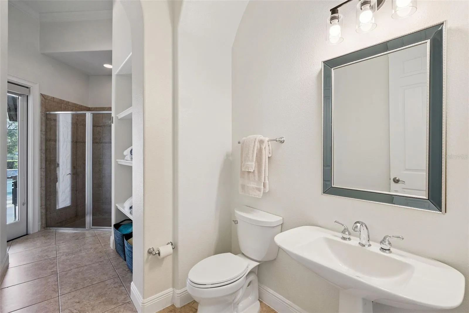 Full pool bathroom with access to the hallway/office and lanai.